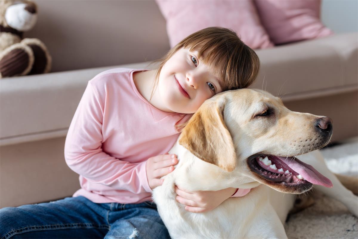 Child with down syndrome cuddling with dog Child with down syndrome cuddling with dog